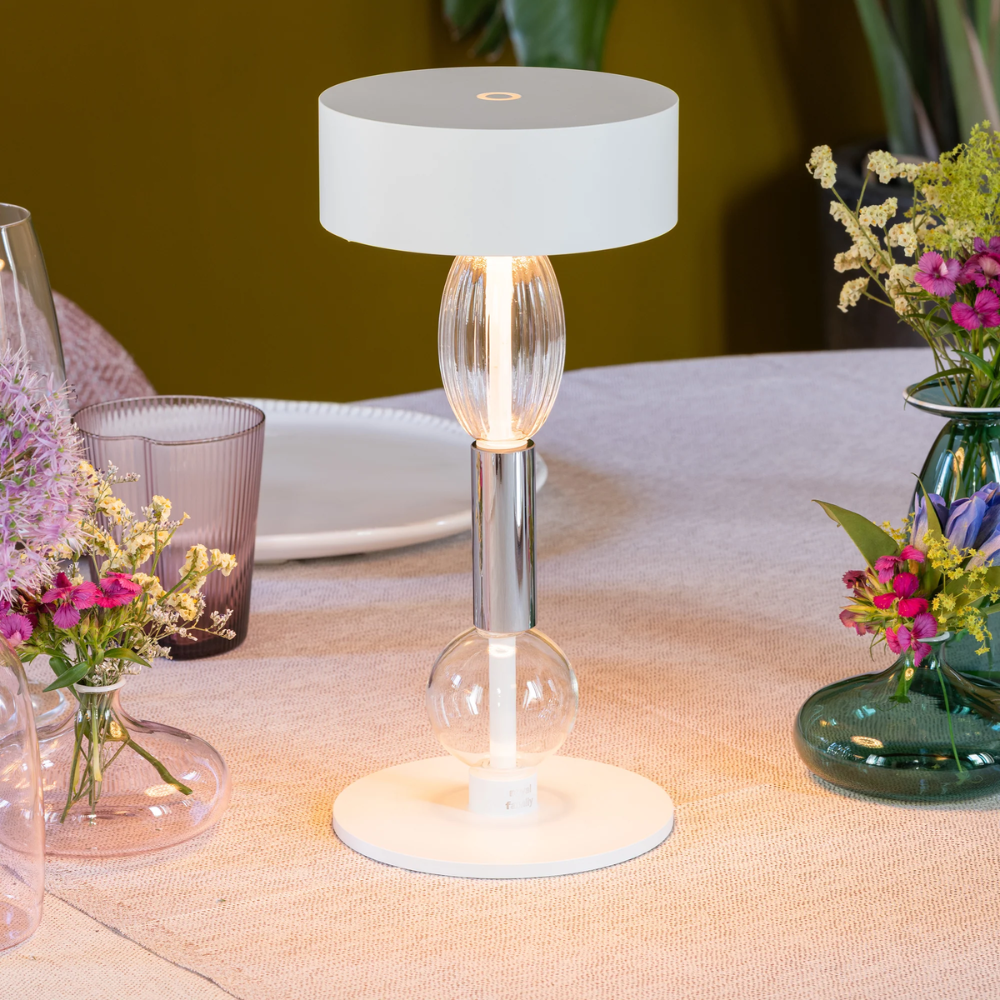 The white with clear and gray glass Royal Family Wi-Fi Table Lamp from Zafferano in a living room.