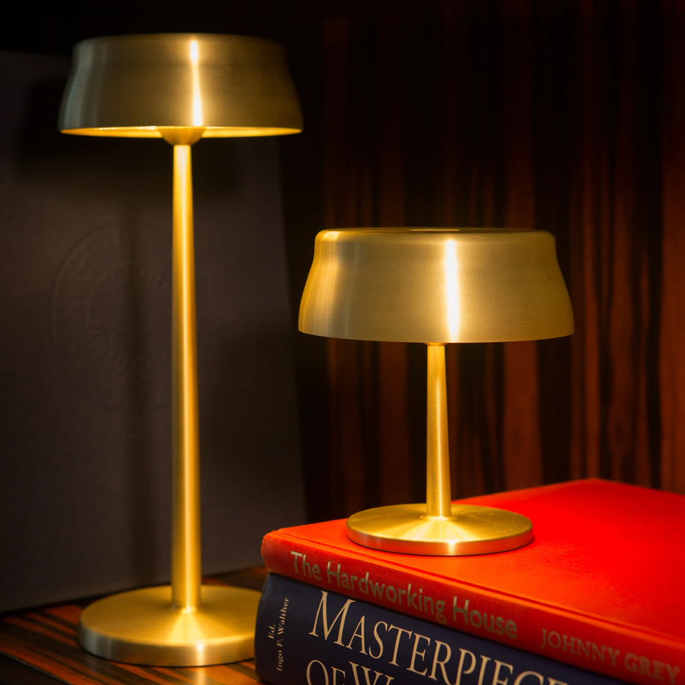 The anodized gold Sister Light Mini Wi-Fi Table Lamp from Zafferano in a home office with the Sister Table Lamp.