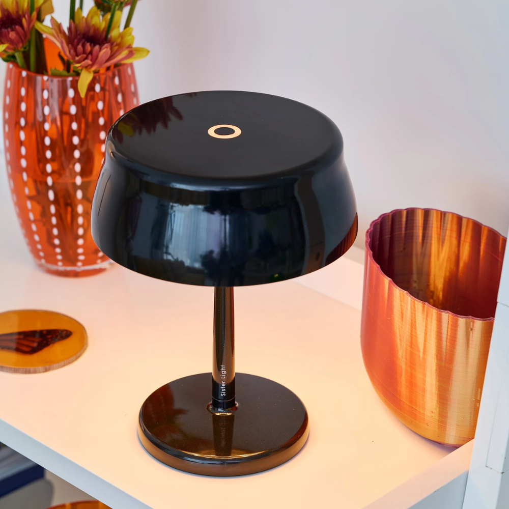 The pearl black Sister Light Mini Wi-Fi Table Lamp from Zafferano in a living space.