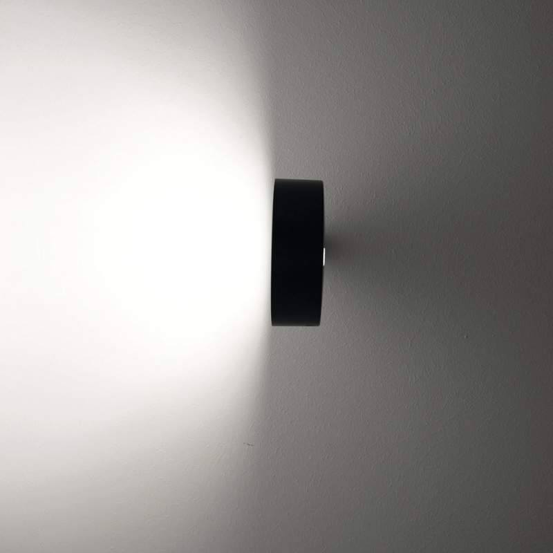 The black Super O Wall Spotlight from Zafferano lighting from a side angle.