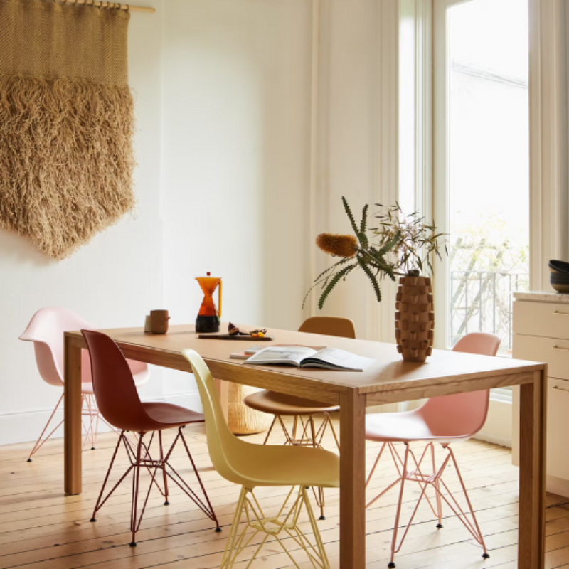 The Eames Molded Plastic Armchair by Herman Miller x HAY in a lounge area.