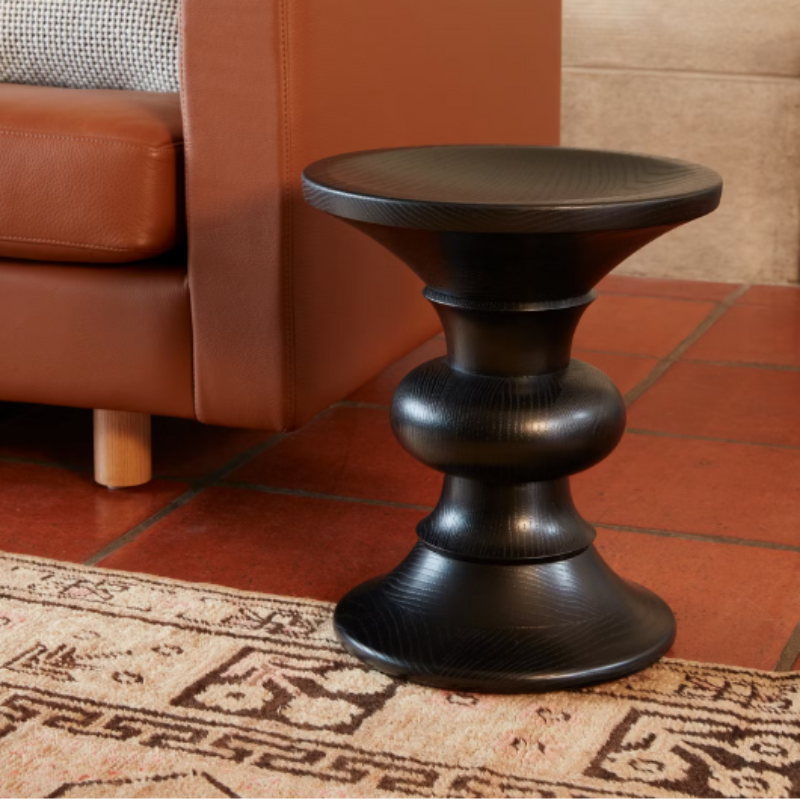 The Eames Turned Stool from Herman Miller in a living room.