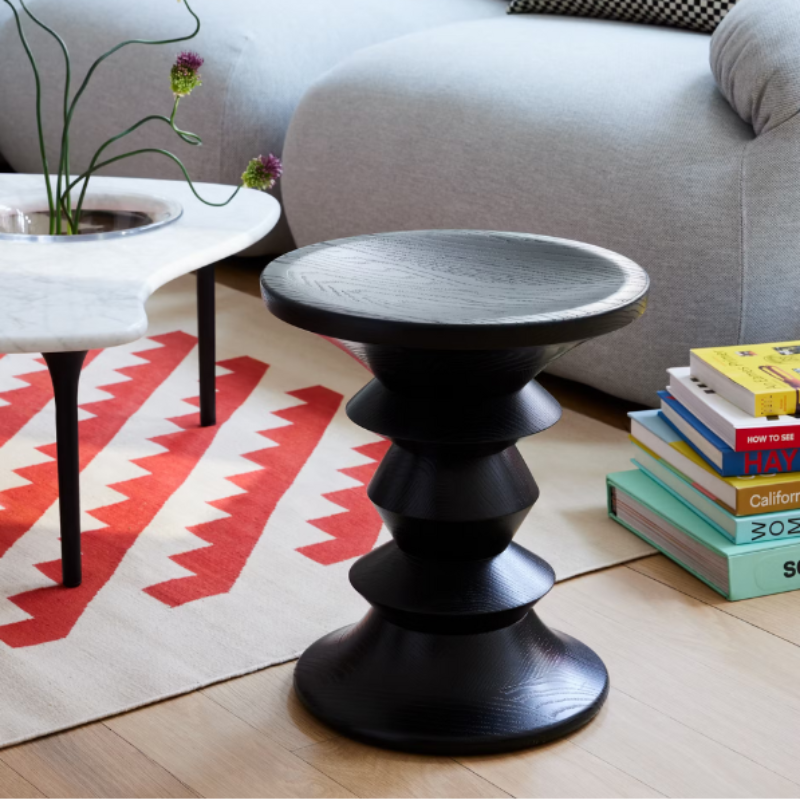 The Eames Turned Stool from Herman Miller in a lounge.