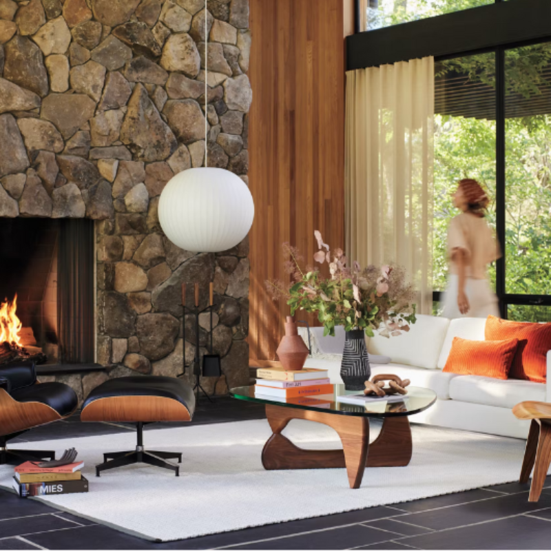 The Noguchi Table from Herman Miller in a room with a fireplace.
