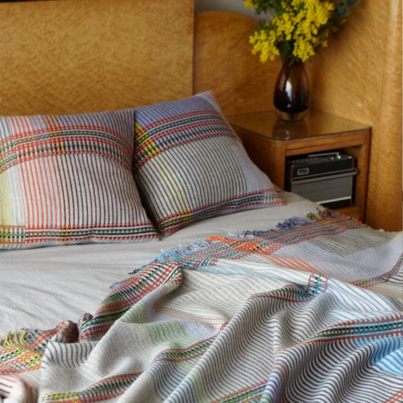 Woven in merino lambswool, Wallace & Sewell's Pinstripe throws combine bold-colored blocks with fine, detailed vertical stripes. This double-sided design also has a contrasting pixelated border and makes a stunning addition to a room.