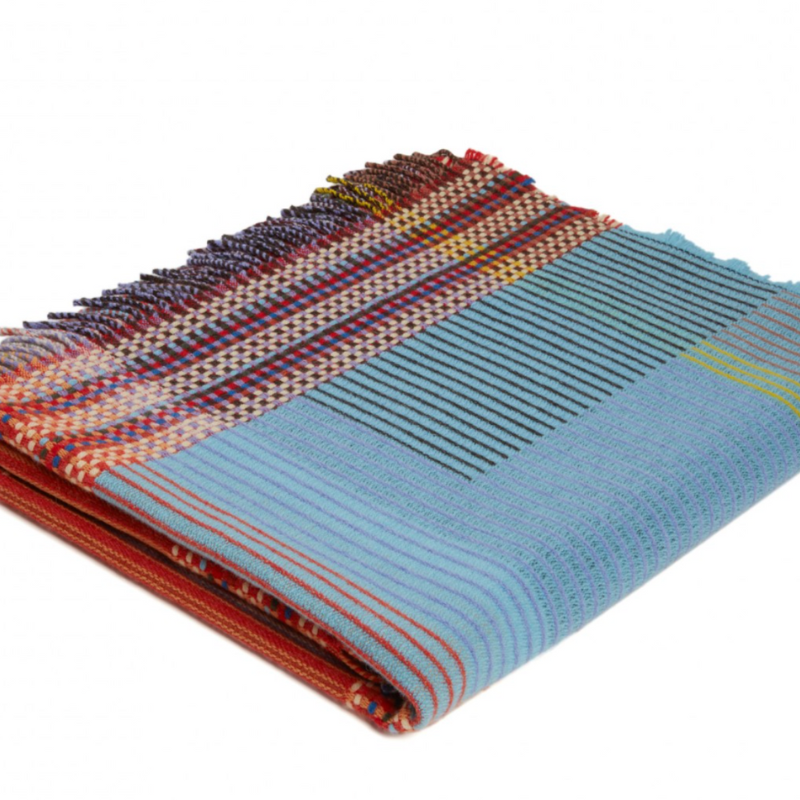 The Beatrix Throw by Wallace & Sewell is made of woven merino lambswool. The Pinstripe collection combines bold-colored blocks with fine, detailed vertical stripes. This double-sided design also has a contrasting pixelated border and is a stunning room addition
