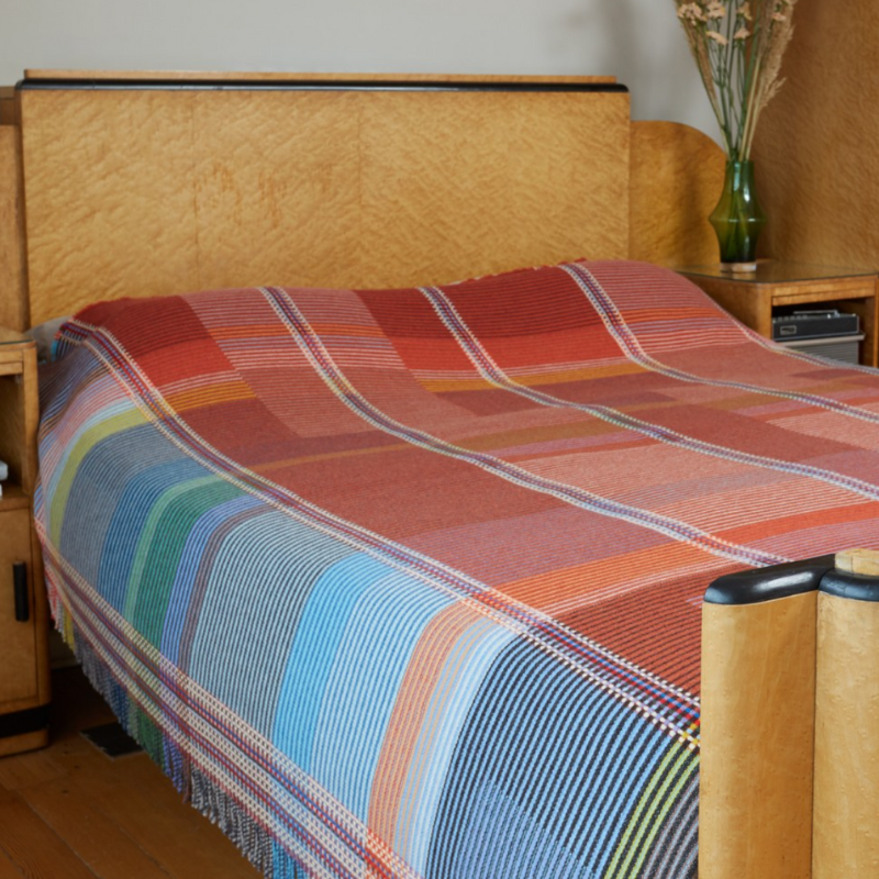 The Beatrix Throw by Wallace & Sewell is made of woven merino lambswool. The Pinstripe collection combines bold-colored blocks with fine, detailed vertical stripes. This double-sided design also has a contrasting pixelated border and is a stunning room addition