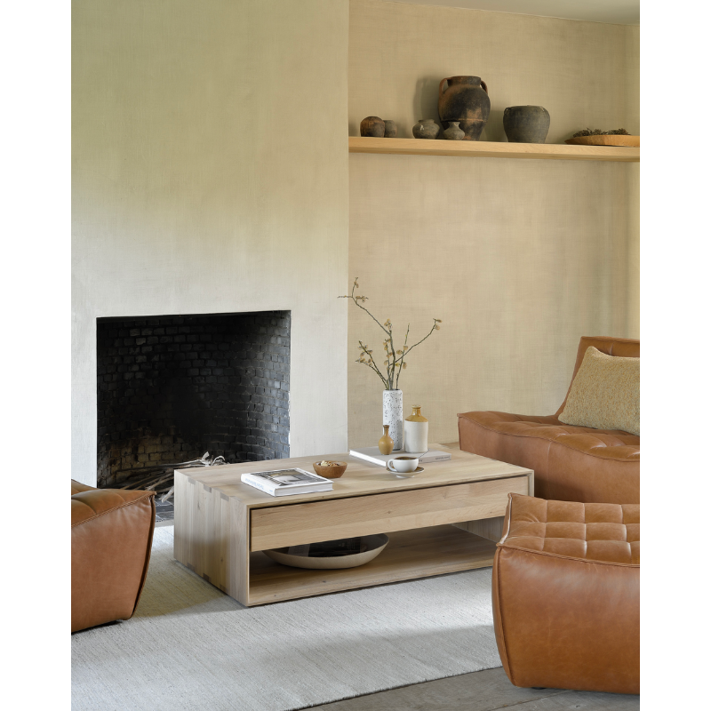 Ethnicraft's Nordic collection combines refined design with the purity of solid wood. The beveled edges give this solid oak furniture an extra edge. The Oak Nordic coffee table conveniently features one storage drawer to stash remotes, coasters, and reading.