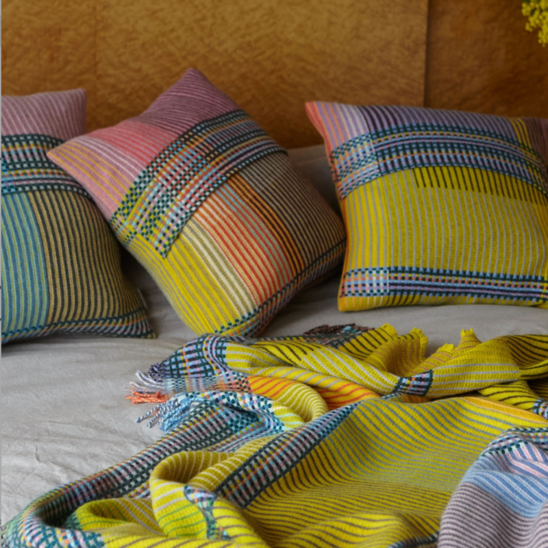 Woven in merino lambswool, Wallace & Sewell's Pinstripe throws combine bold-colored blocks with fine, detailed vertical stripes. This double-sided design also has a contrasting pixelated border and makes a stunning addition to a room.
