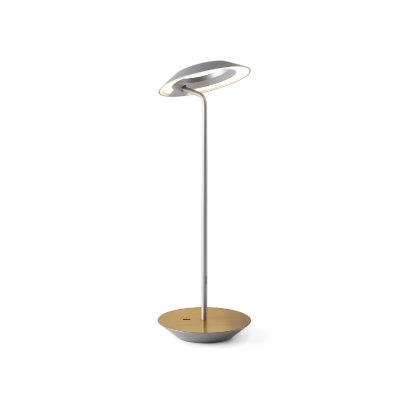 A simultaneously retro and modern desk lamp that combines elegance and inviting warmth. The Royyo Desk Lamp by Koncept will bring whimsy and charm to your desk, as well as super useful and energy-efficient LED illumination. Inventive simplicity is the value that holds together each piece of the desk lamp’s aesthetic, with a somewhat conical shade held at a distinct angle by a thin Aluminum stem. This is contrasted neatly by a distinctively shaped base.