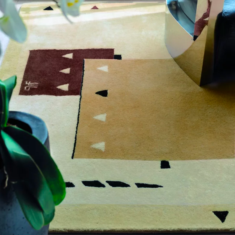 The Silva Area Rug from Toulemonde Boachart enlivens its surroundings with a signature, retro appeal. A rectangular piece created by Jean-Jacques Beaumé and made from New Zealand wool, it utilizes his experience with 1930s design, creating an updated, abstract presence that plays with stacked, interspersed rectangular patterns. These contrasting rectangles are further embellished by small triangles and wavy, segmented lines, creating a playful, enduring presence.