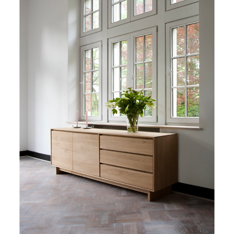 The Wave Sideboard by Ethnicraft features contoured cabinet doors and a distinguished shape to the feet. Made of solid wood, this cabinet’s doors and drawers have no handles and feature a soft closing mechanism. Credenza in living room storage.