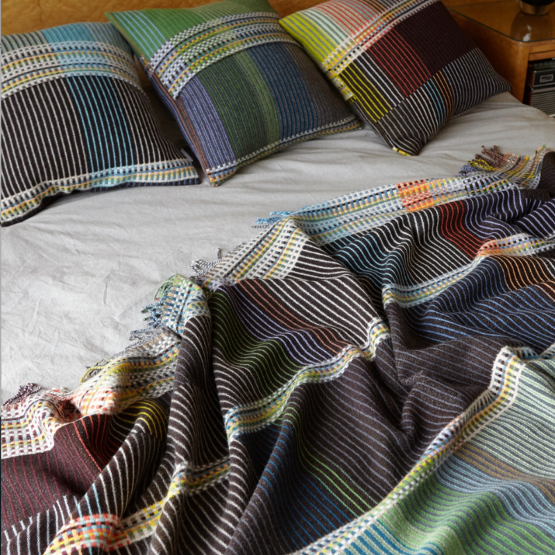 Woven in merino lambswool, Wallace & Sewell's Pinstripe throws combine bold-colored blocks with fine, detailed vertical stripes. This double-sided design also has a contrasting pixelated border and makes a stunning addition to a room.