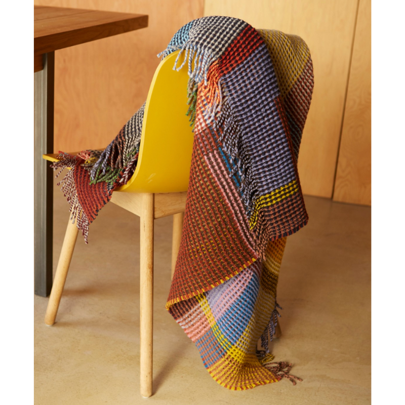 The Edith Honeycomb Throw from Wallace & Sewell made from 100% merino lambswool in the United Kingdom.
