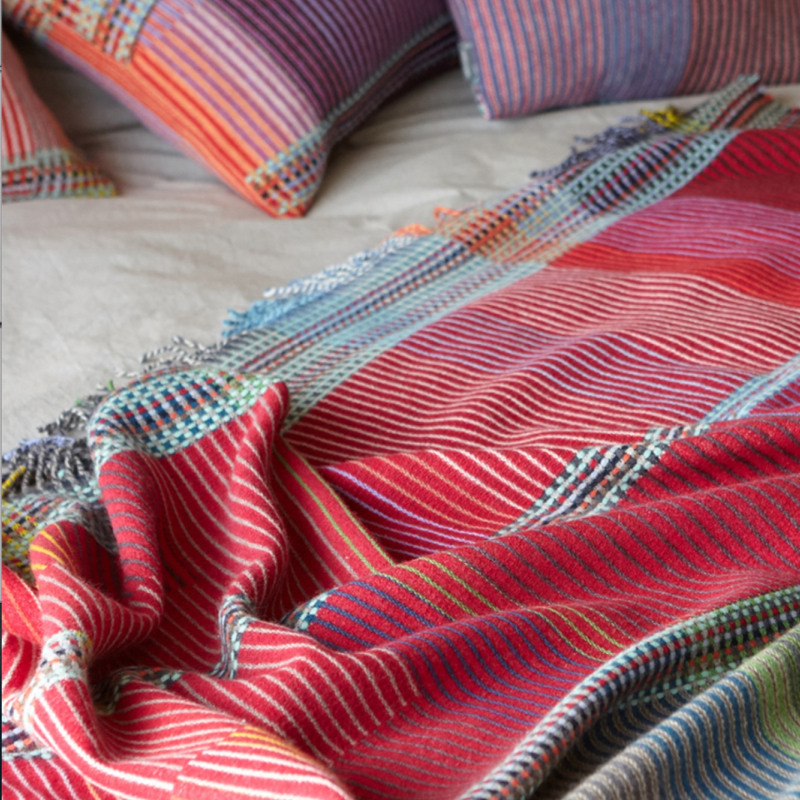 Woven in merino lambswool, Wallace & Sewell's Pinstripe throws combine bold-colored blocks with fine, detailed vertical stripes. This double-sided design also has a contrasting pixelated border and makes a stunning addition to a room.