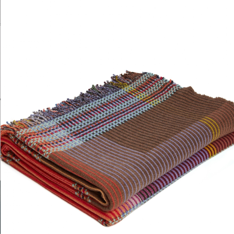 Woven in merino lambswool, Wallace & Sewell's Pinstripe throws combine bold-colored blocks with fine, detailed vertical stripes. This double-sided design also has a contrasting pixelated border and makes a stunning addition to a room.