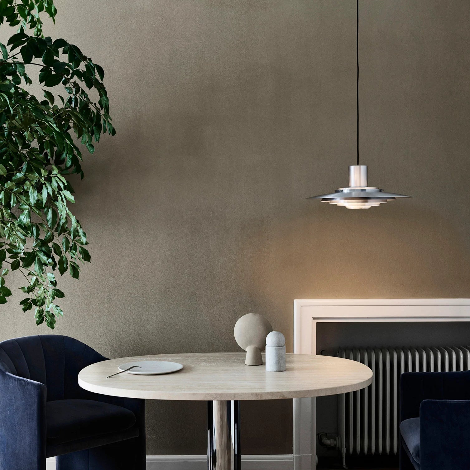 The P376 pendant lamp is a perfect example of subtle architectural slant on design. Originally conceived in 1963 by Danish architects Kastholm & Fabricius and relaunched by &Tradition in 2019, the P376 features five concentric shades that create gradations of curves towards the middle of the lamp to emit a soft, diffused light. The discrete placement of the shades and the silky aluminium finish culminate in a cohesive expression that’s both iconic and enthralling. 