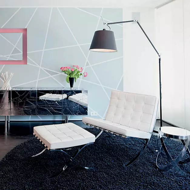 The Tolomeo Mega Floor Lamp from Artemide in black with a 14-inch shade in a lounge.