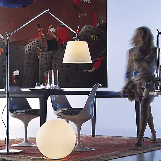 The Tolomeo Mega Floor Lamp from Artemide in parchment with a 17-inch shade in a dining space.