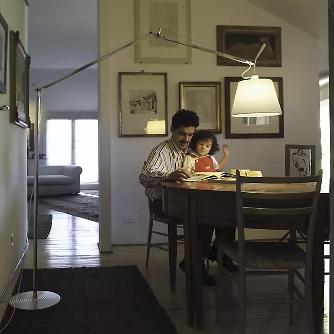 The Tolomeo Mega Floor Lamp from Artemide in parchment with a 17-inch shade in a study room.