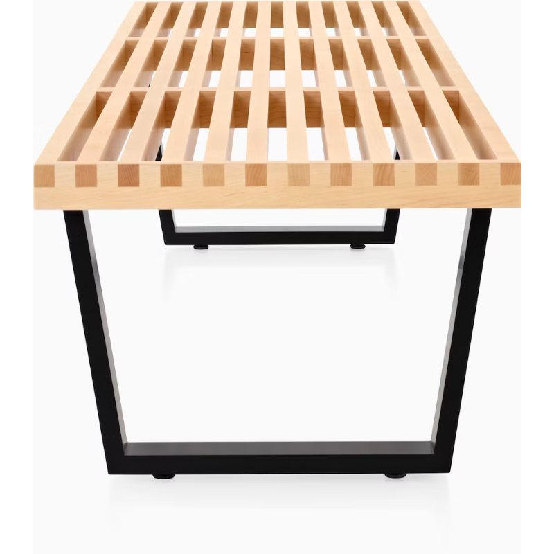 The Nelson Platform Bench from Herman Miller in maple with the wood base in a detailed shot.