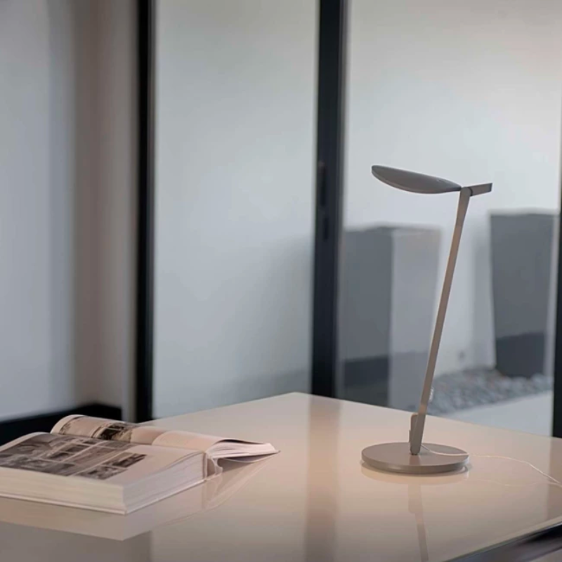 The Splitty Desk Lamp from Koncept in grey in a home office.