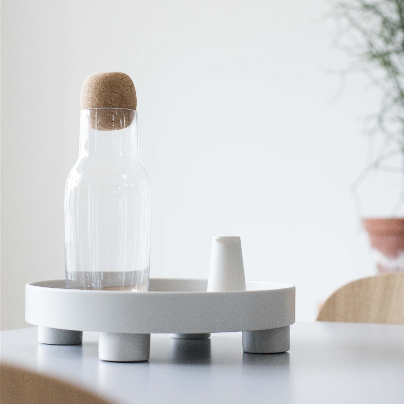 The Platform Tray by Muuto in gray on a dining table.