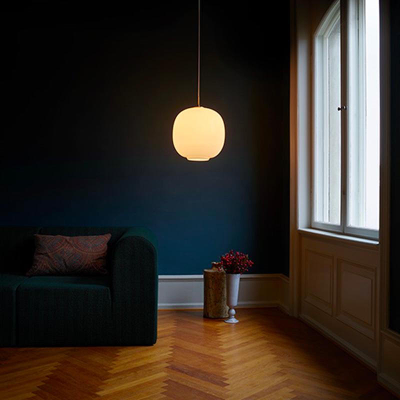 Originally designed in the 1940s by Vilhelm Lauritzen for a project in Copenhagen, the Louis Poulsen VL45 Radiohus Pendant is everything we love about modern design. The lantern shape is smooth and crisply rendered from three layers of hand-blown glass, casting a glowing light from its center that is both functional and beautiful to witness. The glass is topped with a Brushed Brass tube, adding a nice metallic accent to the warmth of the opal glass.