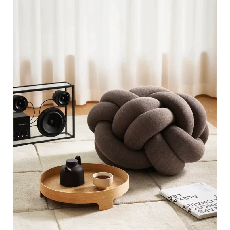 The versatile Knot Seat Cushion, Medium is a unique floor cushion that doubles as an ottoman, extra seating, or a decorative element in any living space. Crafted with a sculptural form instead of traditional patterns, this cushion is unlike anything you've seen. 