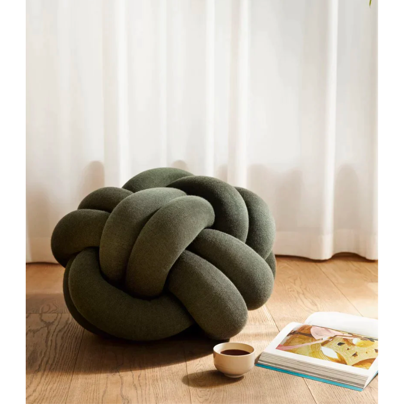 The versatile Knot Seat Cushion, Medium is a unique floor cushion that doubles as an ottoman, extra seating, or a decorative element in any living space. Crafted with a sculptural form instead of traditional patterns, this cushion is unlike anything you've seen. 