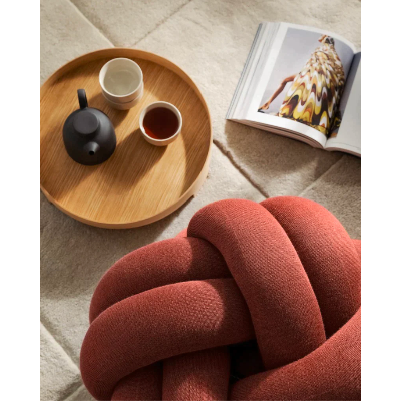 The versatile Knot Seat Cushion, Medium is a unique floor cushion that doubles as an ottoman, extra seating, or a decorative element in any living space. Crafted with a sculptural form instead of traditional patterns, this cushion is unlike anything you've seen. 