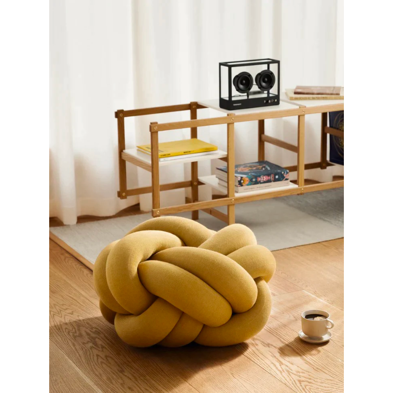 The versatile Knot Seat Cushion, Medium is a unique floor cushion that doubles as an ottoman, extra seating, or a decorative element in any living space. Crafted with a sculptural form instead of traditional patterns, this cushion is unlike anything you've seen. 