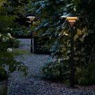 The PH 3-2½ Bollard from Louis Poulsen outdoor by a path.