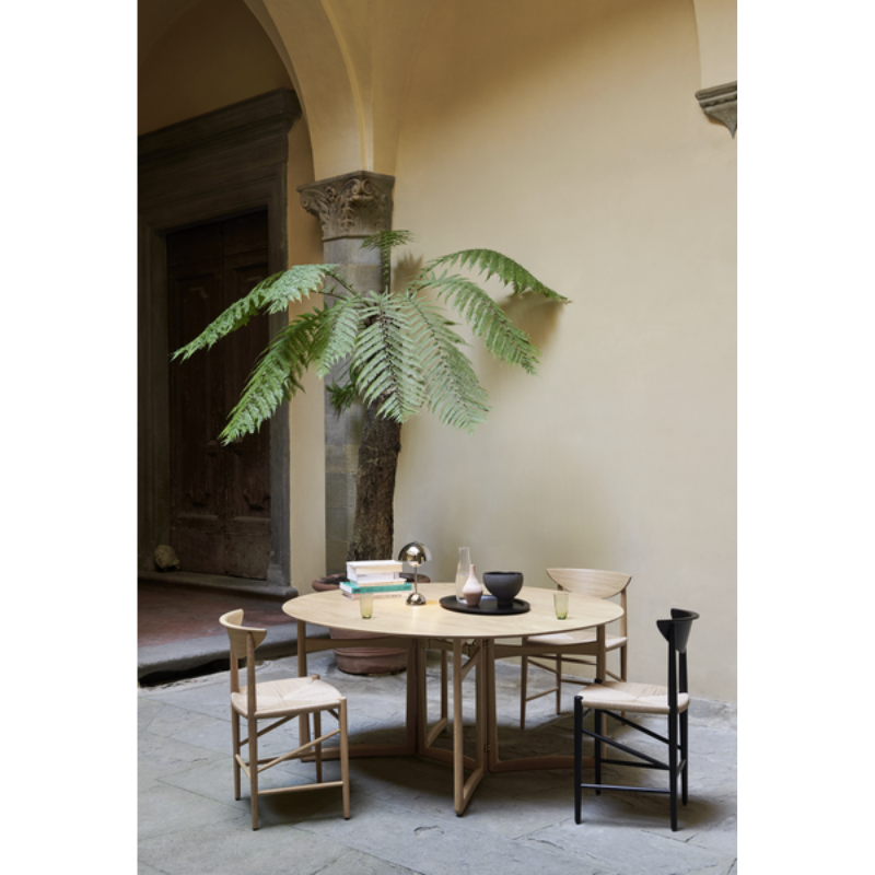 The Flowerpot VP9 Portable Table Lamp from &Tradition in a dining space with a high ceiling.