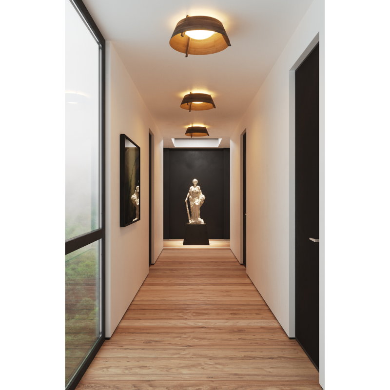 The Casia Flush Mount from Cerno in a hallway leading to a sculpture in a living room lifestyle photograph.
