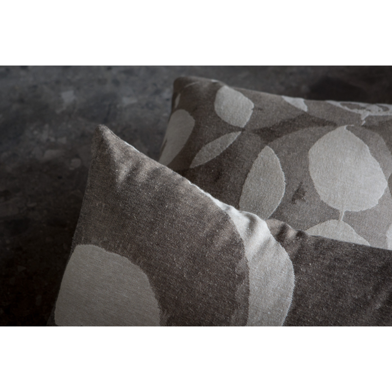 The Abstract Detail Cushion by Ethnicraft in a family lifestyle photograph.
