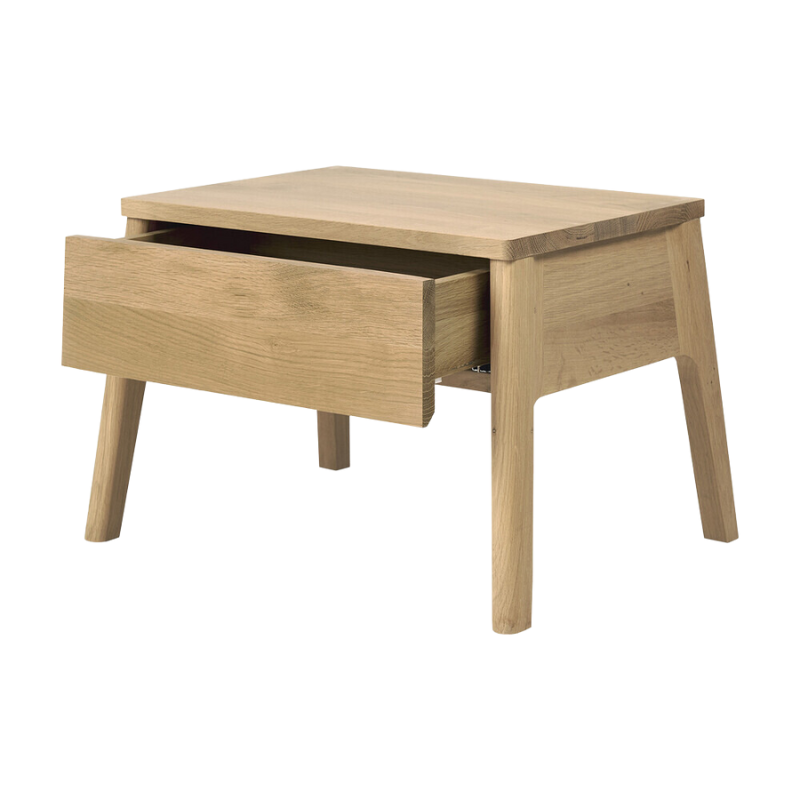The solid oak Air Bedside Table from Ethnicraft with its drawer slightly opened.