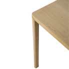 The Air Dining Table from Ethnicraft in a detailed close up shot showing the solid oak legs, corner and table top.