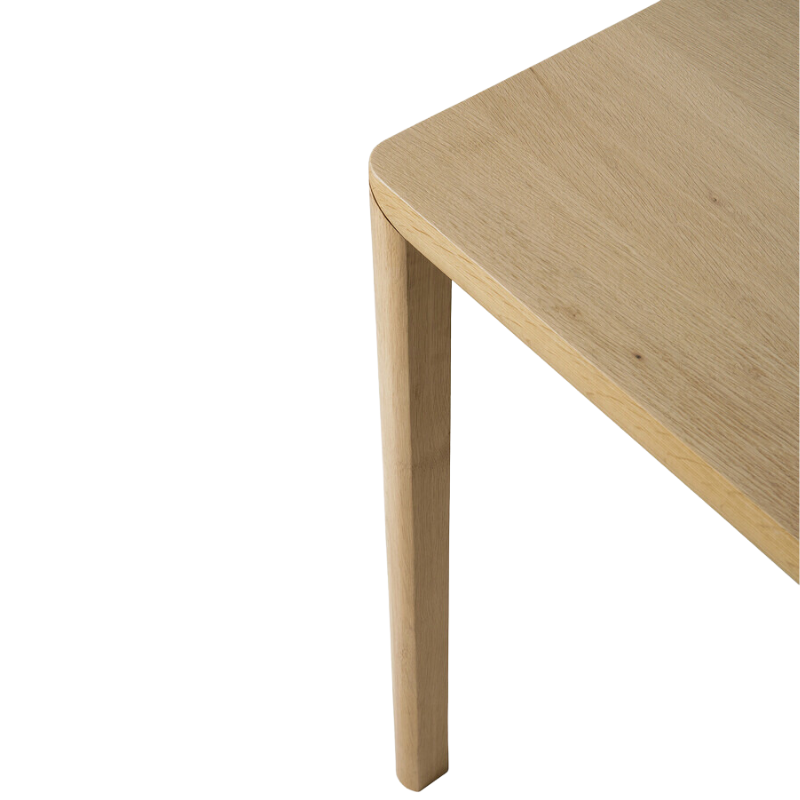 The Air Dining Table from Ethnicraft in a detailed close up shot showing the solid oak legs, corner and table top.