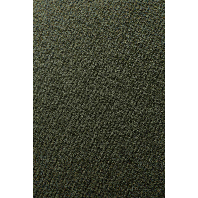 A close up showing the pine green fabric option of the Barrow Lounge Chair from Ethnicraft.