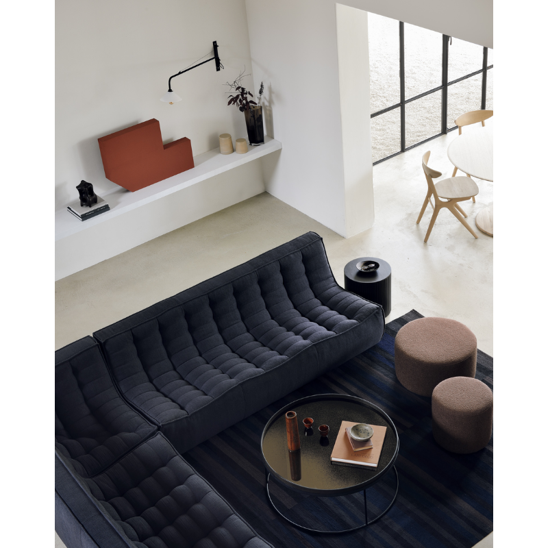 The Barrow Pouf by Ethnicraft alongside other Ethnicraft furniture found in a living room.