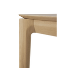 The Bok Bench from Ethnicraft in the oak finish with a close up on the corner of the bench.