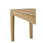 The Bok Bench from Ethnicraft in the oak finish with a close up on the legs of the bench.