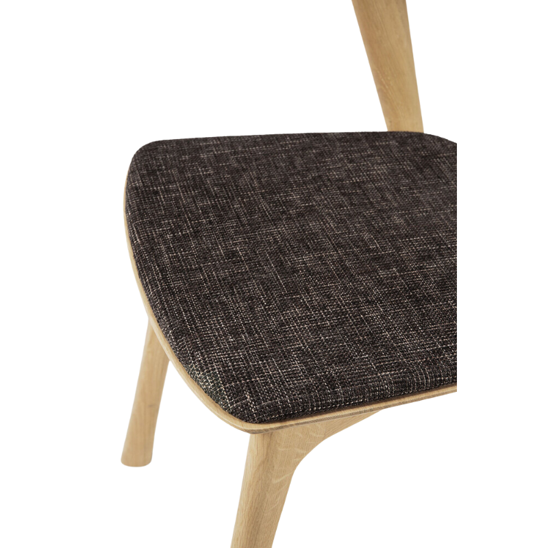 The Bok Dining Chair from Ethnicraft in oak with dark brown upholstery.