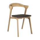 The Bok Dining Chair from Ethnicraft in oak with dark brown upholstery.