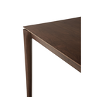 The Bok Dining Table from Ethnicraft in brown teak, in a detailed close up shot.