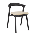 The Bok Outdoor Dining Chair from Ethnicraft in black teak with a cushion in natural color.
