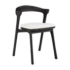 The Bok Outdoor Dining Chair from Ethnicraft in black teak with a cushion in off white color.