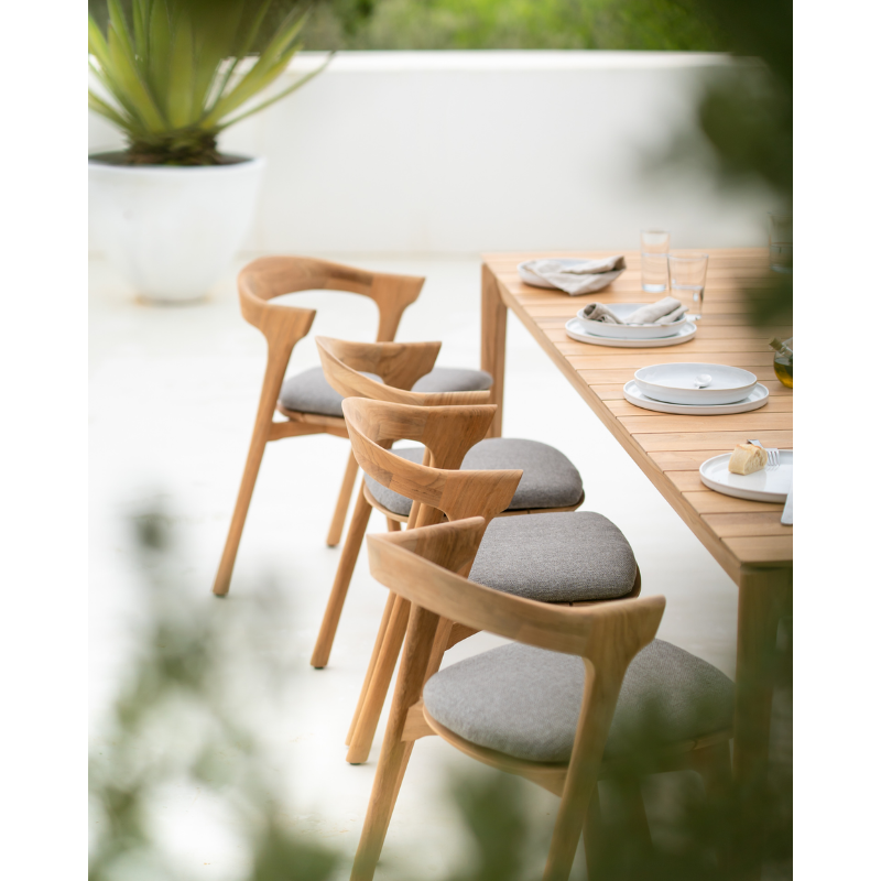 The Bok Outdoor Dining Chair from Ethnicraft set up outdoors for dining.