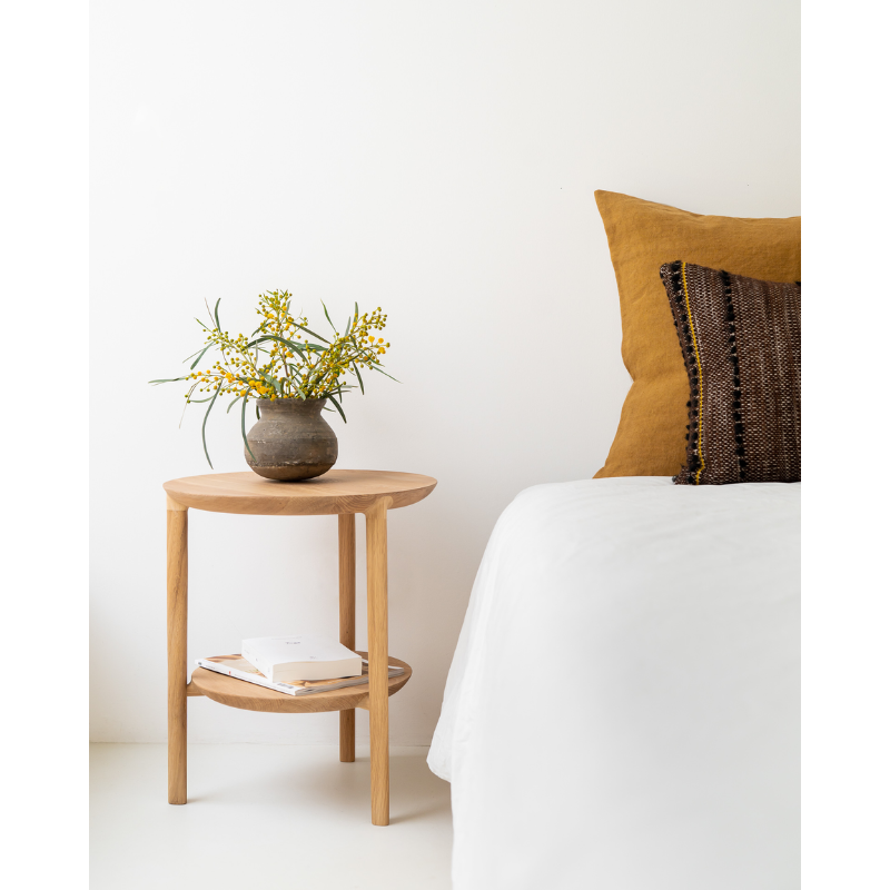 The Bok Side Table from Ethnicraft in a bedroom.